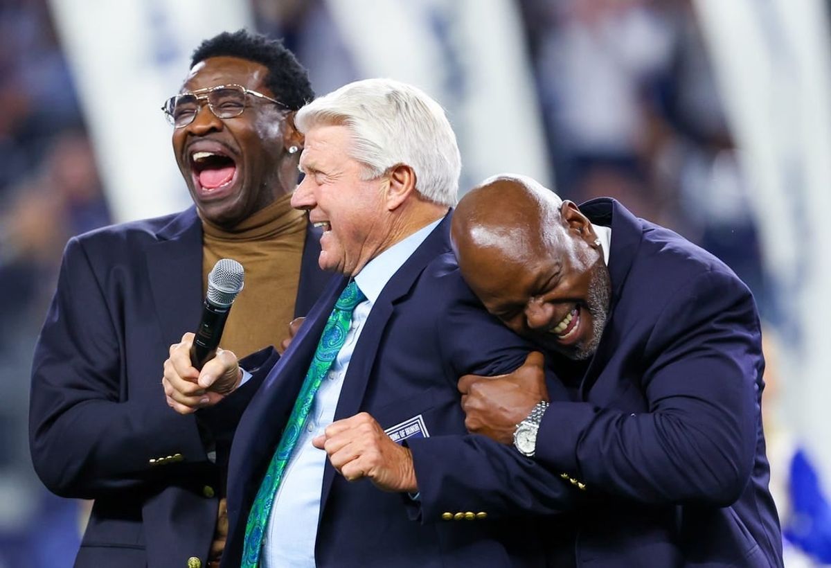 Dec 30, 2023; Arlington, Texas, USA;  Dallas Cowboys former head coach Jimmy Johnson celebrates with former players Michael Irvin and Emmitt Smith after being inducted into the ring of honor at halftime of the game against the Detroit Lions at AT&T Stadium.