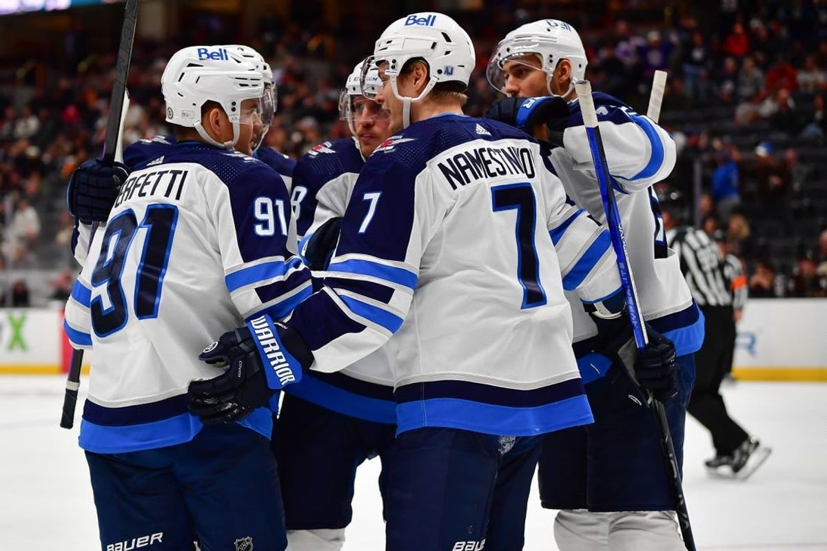Jan 5, 2024; Anaheim, California, USA; Winnipeg Jets celebrate the goal scored by center Cole Perfetti (91) against the Anaheim Ducks during the third period at Honda Center.