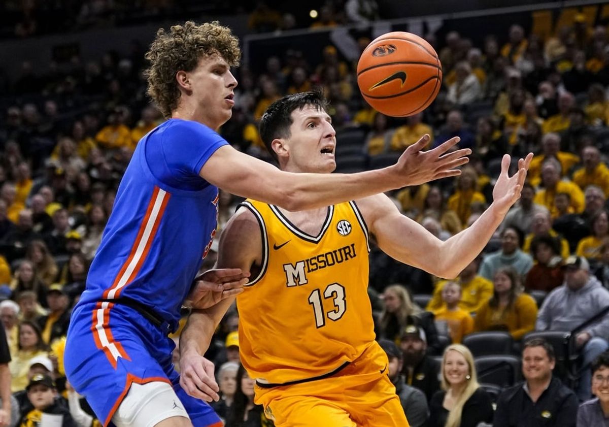 Jan 20, 2024; Columbia, Missouri, USA; Missouri Tigers forward Jesus Carralero Martin (13) loses control of the ball as he drives against Florida Gators center Micah Handlogten (3) during the first half at Mizzou Arena.