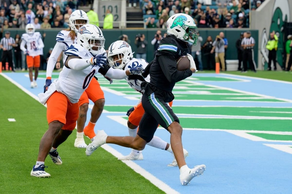 Nov 24, 2023; New Orleans, Louisiana, USA; Tulane Green Wave wide receiver Chris Brazzell II (17) runs around UTSA Roadrunners defensive back Ken Robinson (21) for a touchdown during the first half at Yulman Stadium.