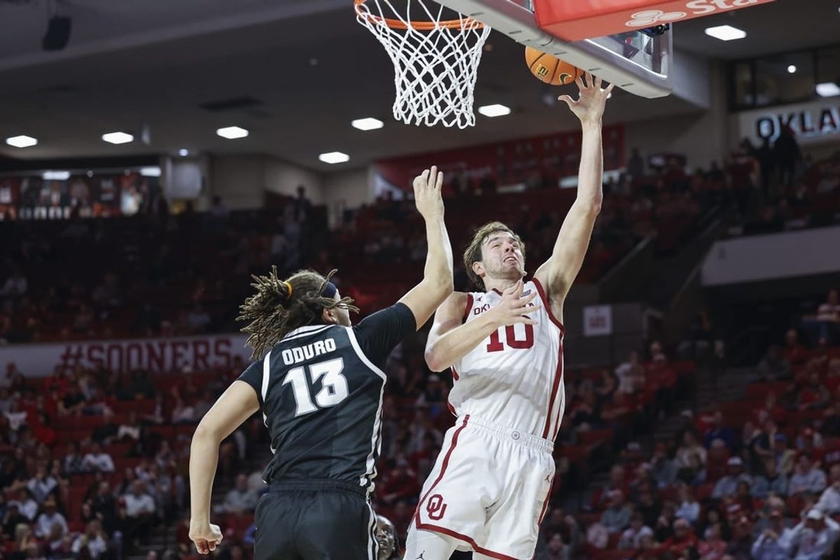Dec 5, 2023; Norman, Oklahoma, USA; Oklahoma Sooners forward Sam Godwin (10) shoots as Providence Friars forward Josh Oduro (13) defends during the second half at Lloyd Noble Center.
