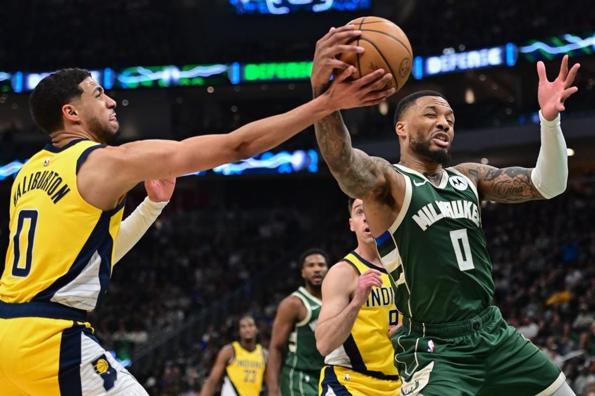 Apr 21, 2024; Milwaukee, Wisconsin, USA; Milwaukee Bucks guard Damian Lillard (0) and Indiana Pacers guard Tyrese Haliburton (0) battle for a rebound in the in the second quarter during game one of the first round for the 2024 NBA playoffs at Fiserv Forum.