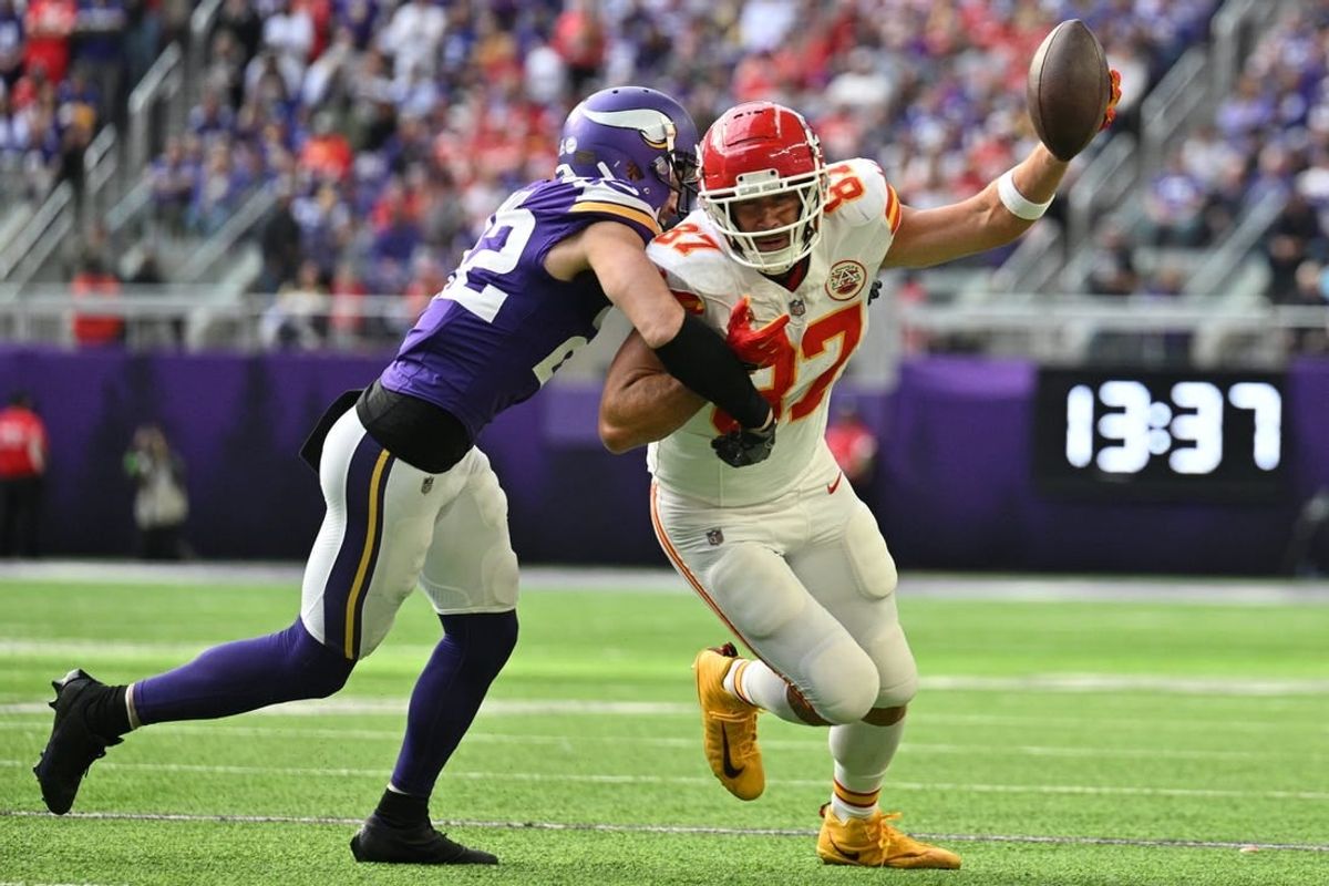 Oct 8, 2023; Minneapolis, Minnesota, USA; Kansas City Chiefs tight end Travis Kelce (87) gets yards after the catch as Minnesota Vikings safety Harrison Smith (22) makes a tackle during the second quarter at U.S. Bank Stadium.