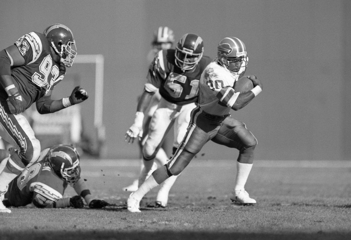 Dec 1, 1985; San Diego, CA, USA; FILE PHOTO; Buffalo Bills running back Joe Cribbs (20) is chased by San Diego Chargers defensive tackle Earl Wilson (93) and Woodrow Lowe (51) at Jack Murphy Stadium. Mandatory Credit: Peter Brouillet-Imagn Images
