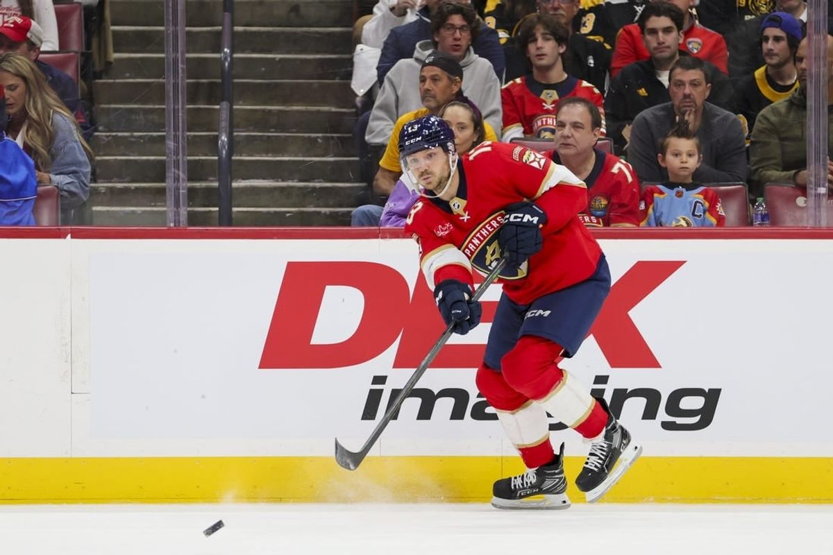Nov 22, 2023; Sunrise, Florida, USA; Florida Panthers center Sam Reinhart (13) passes the puck against the Boston Bruins during the first period at Amerant Bank Arena.