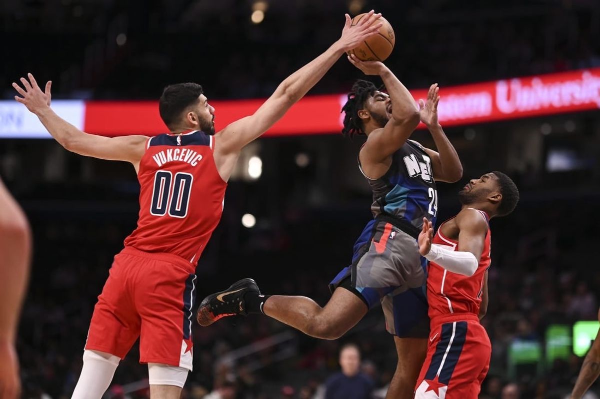 Mar 27, 2024; Washington, District of Columbia, USA;  Washington Wizards forward Tristan Vukcevic (00) blocks Brooklyn Nets guard Cam Thomas (24) shot during the first half at Capital One Arena.