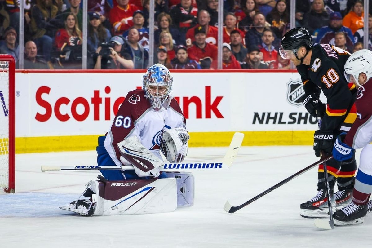 Mar 12, 2024; Calgary, Alberta, CAN; Colorado Avalanche goaltender Justus Annunen (60) makes a save against Calgary Flames center Jonathan Huberdeau (10) during the second period at Scotiabank Saddledome.