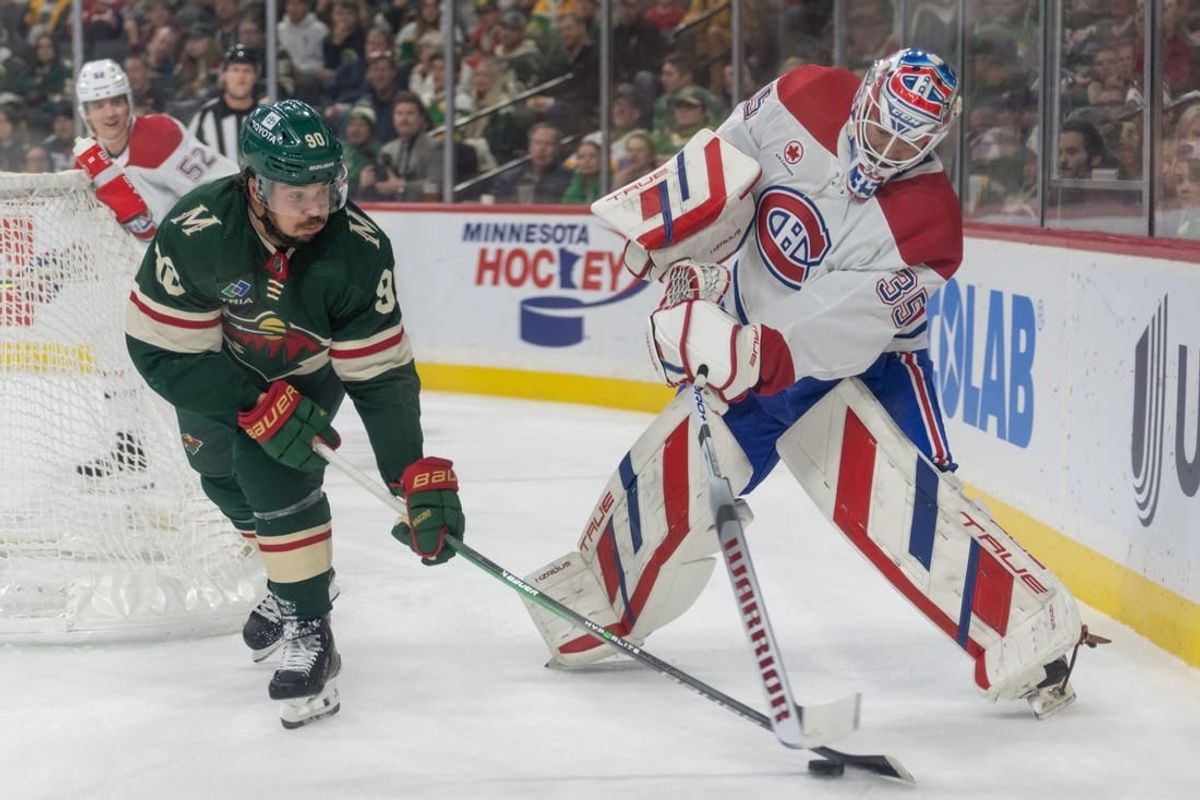 Dec 21, 2023; Saint Paul, Minnesota, USA; Minnesota Wild left wing Marcus Johansson (90) steals the puck behind the net from Montreal Canadiens goaltender Sam Montembeault (35) in the first period at Xcel Energy Center.