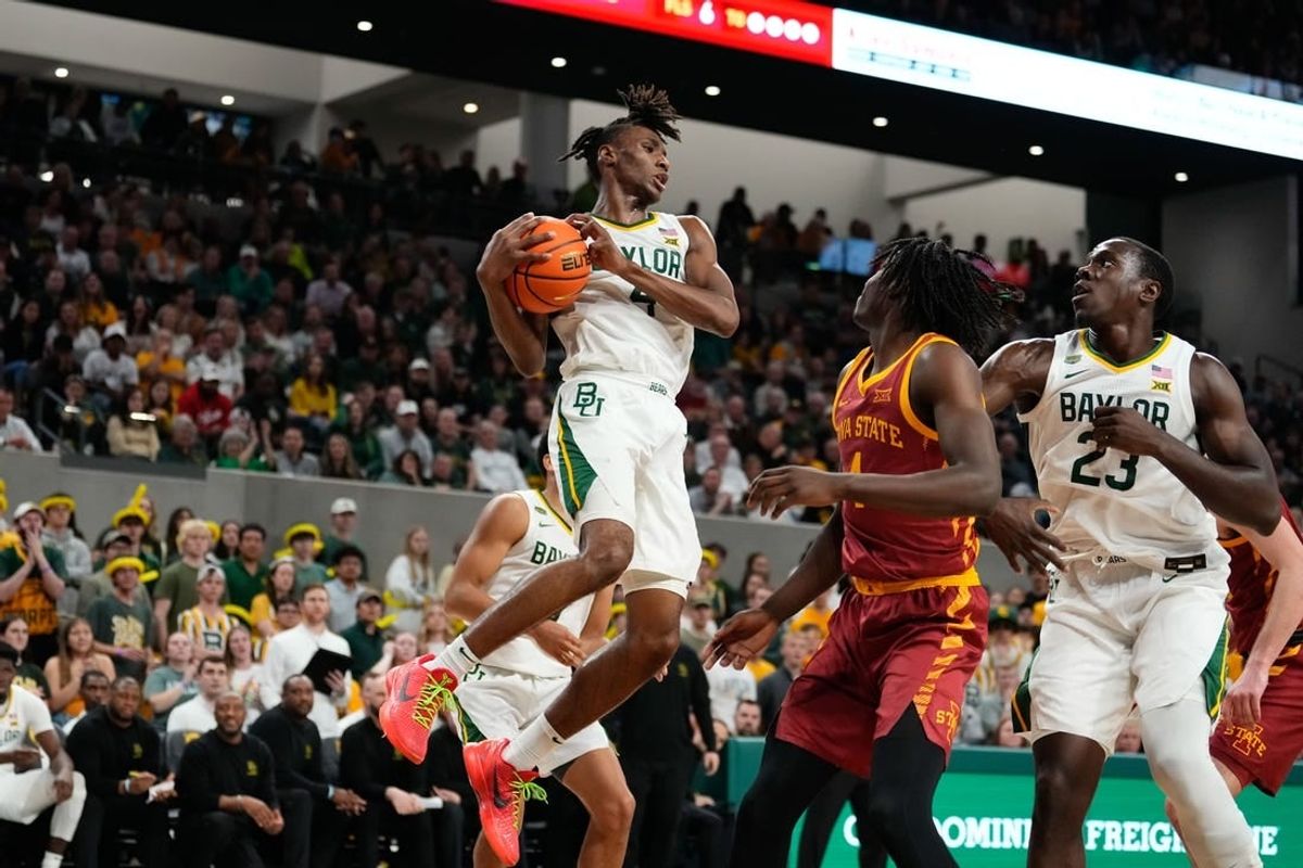 Feb 3, 2024; Waco, Texas, USA; Baylor Bears guard Ja'Kobe Walter (4) grabs a rebound against the Iowa State Cyclones during the first half at Paul and Alejandra Foster Pavilion.
