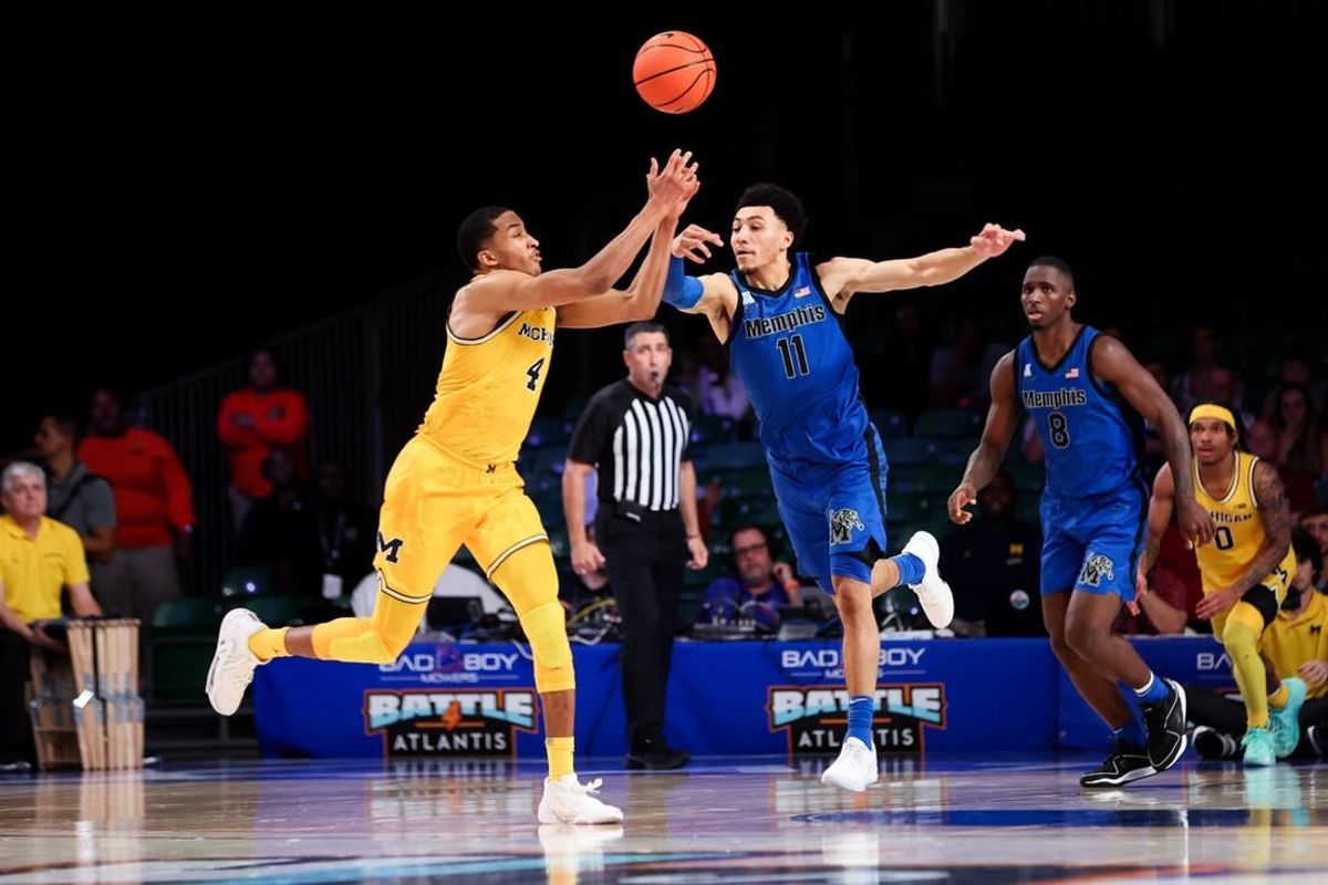 Nov 22, 2023; Paradise Island, BAHAMAS;  Michigan Wolverines guard Nimari Burnett (4) and Memphis Tigers guard Jahvon Quinerly (11) go for the ball during the second half at Imperial Arena.