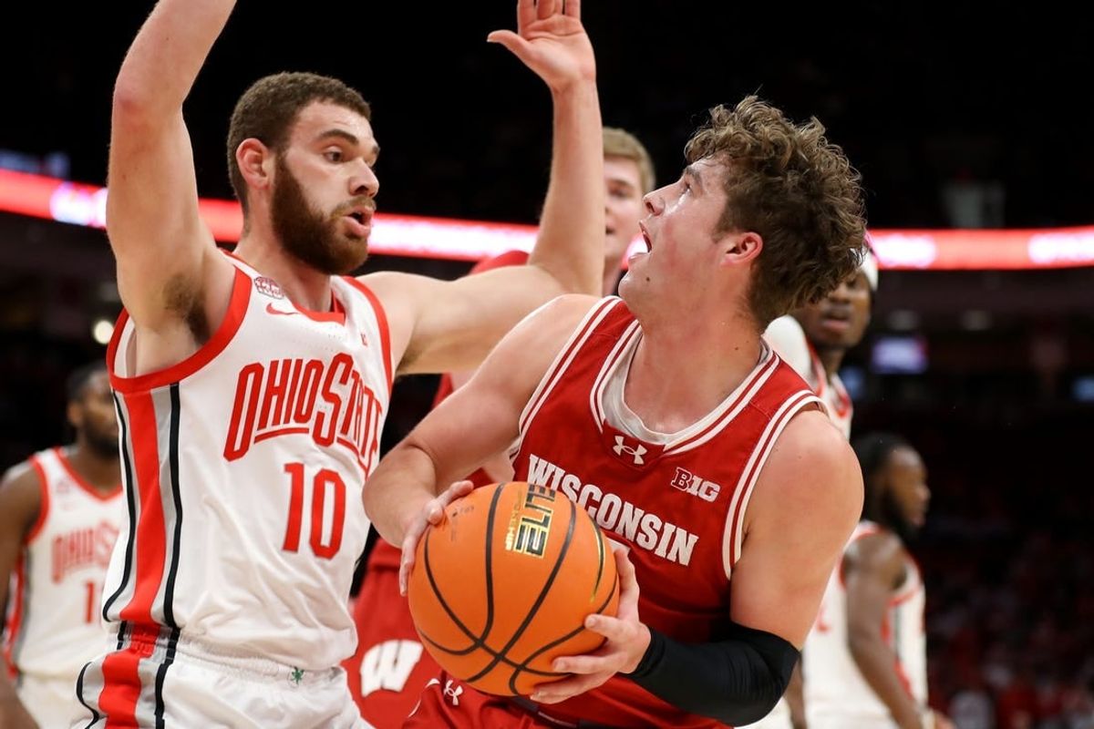 Jan 10, 2024; Columbus, Ohio, USA; Wisconsin Badgers guard Max Klesmit (11) looks for the shot as Ohio State Buckeyes forward Jamison Battle (10) defends during the first half at Value City Arena.