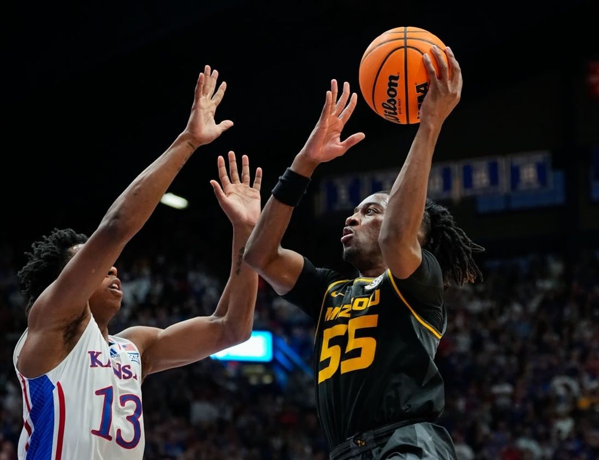 Dec 9, 2023; Lawrence, Kansas, USA; Missouri Tigers guard Sean East II (55) shoots against Kansas Jayhawks guard Elmarko Jackson (13) during the first half at Allen Fieldhouse.