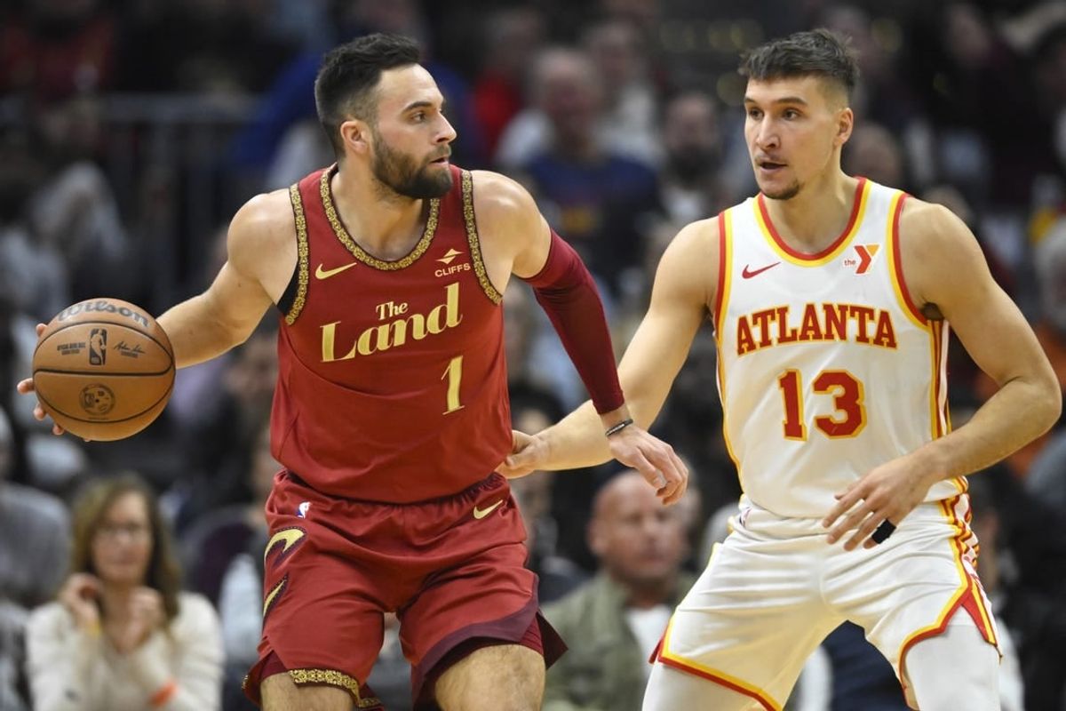 Nov 28, 2023; Cleveland, Ohio, USA; Atlanta Hawks guard Bogdan Bogdanovic (13) defends Cleveland Cavaliers guard Max Strus (1) in the second quarter at Rocket Mortgage FieldHouse.