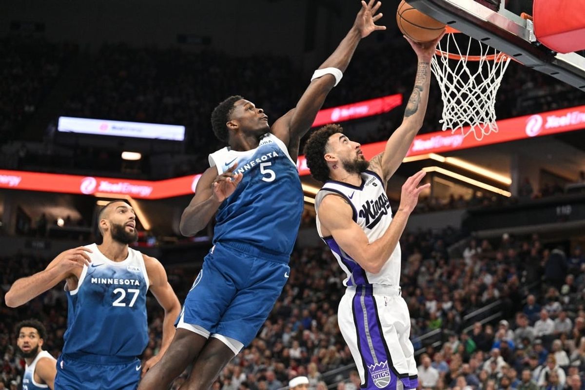 Nov 24, 2023; Minneapolis, Minnesota, USA; Minnesota Timberwolves guard Anthony Edwards (5) blocks the shot of Sacramento Kings guard Chris Duarte (3) as center Rudy Gobert (27) looks on during the first quarter at Target Center.