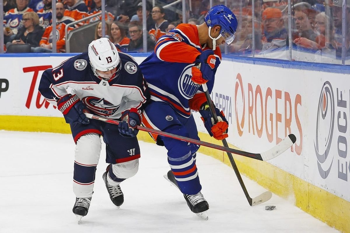 Jan 23, 2024; Edmonton, Alberta, CAN; Columbus Blue Jackets forward Johnny Gaudreau (13) and Edmonton Oilers defensemen Darnell Nurse (25) battle during the second period at Rogers Place.