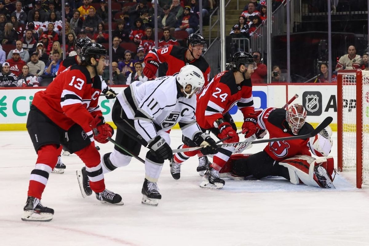 Feb 15, 2024; Newark, New Jersey, USA; New Jersey Devils goaltender Nico Daws (50) makes a glove save on Los Angeles Kings center Anze Kopitar (11) during the first period at Prudential Center.
