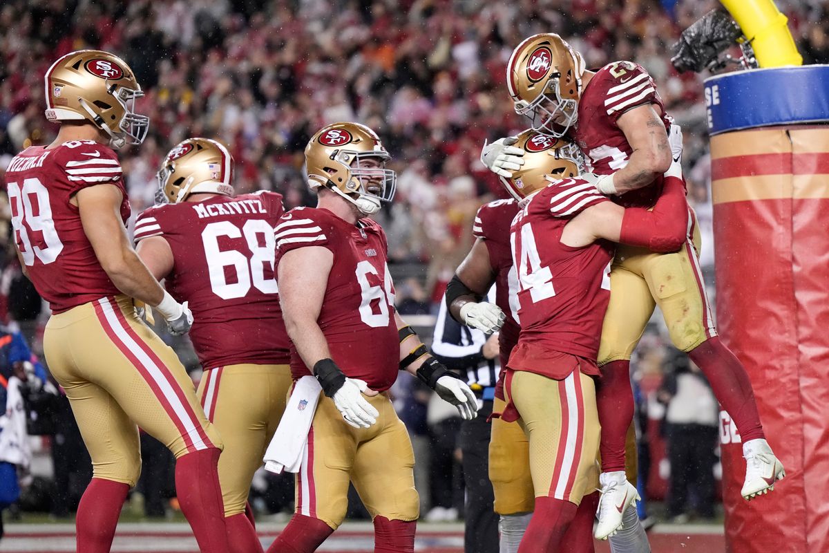 Christian McCaffrey the San Francisco 49ers celebrates with teammates after scoring a 6-yard rushing touchdown during the fourth quarter against the Green Bay Packers in the NFC Divisional Playoffs at Levi's Stadium on January 20, 2024 in Santa Clara, California. (Photo by Thearon W. Henderson/Getty Images)