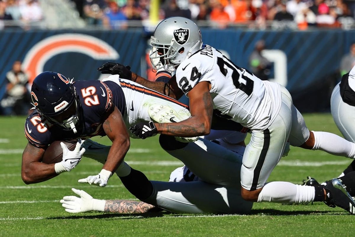 Oct 22, 2023; Chicago, Illinois, USA; Chicago Bears running back Darrynton Evans (25) rushes the ball against Las Vegas Raiders cornerback Marcus Peters (24) in the second half at Soldier Field.