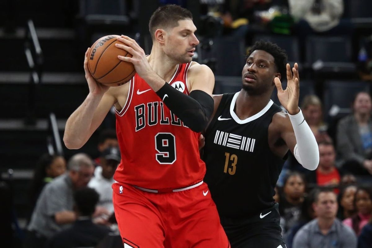Feb 8, 2024; Memphis, Tennessee, USA; Chicago Bulls center Nikola Vucevic (9) handles the ball as Memphis Grizzlies forward-center Jaren Jackson Jr. (13) defends during the first half at FedExForum.