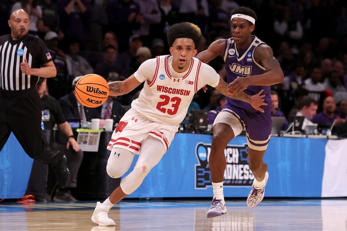Mar 22, 2024; Brooklyn, NY, USA; Wisconsin Badgers guard Chucky Hepburn (23) drives to the basket against James Madison Dukes guard Xavier Brown (0) during the second half at Barclays Center.