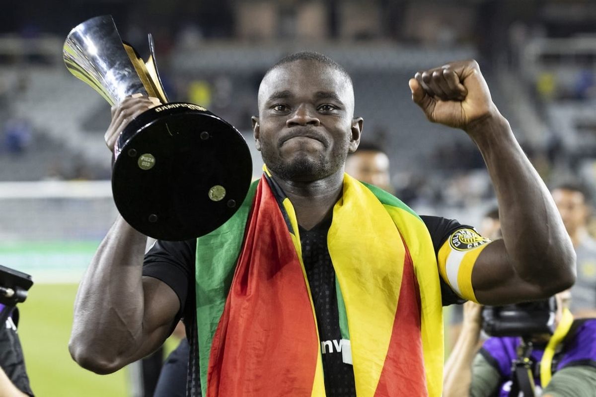 Sep 29, 2021; Columbus, OH, USA; Columbus Crew defender Jonathan Mensah (4) displays the trophy for supporters after defeating Cruz Azul to win the 2021 Campeones Cup match at Lower.com Field