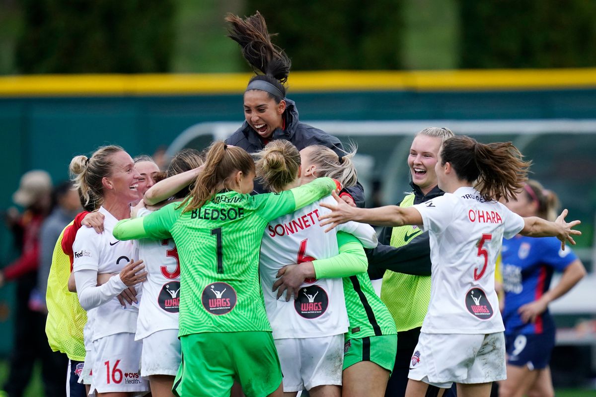 Washington Spirit players celebrate after defeating the OL Reign in the semifinals of the NWSL soccer playoffs Sunday, Nov. 14, 2021, in Tacoma, Wash.
