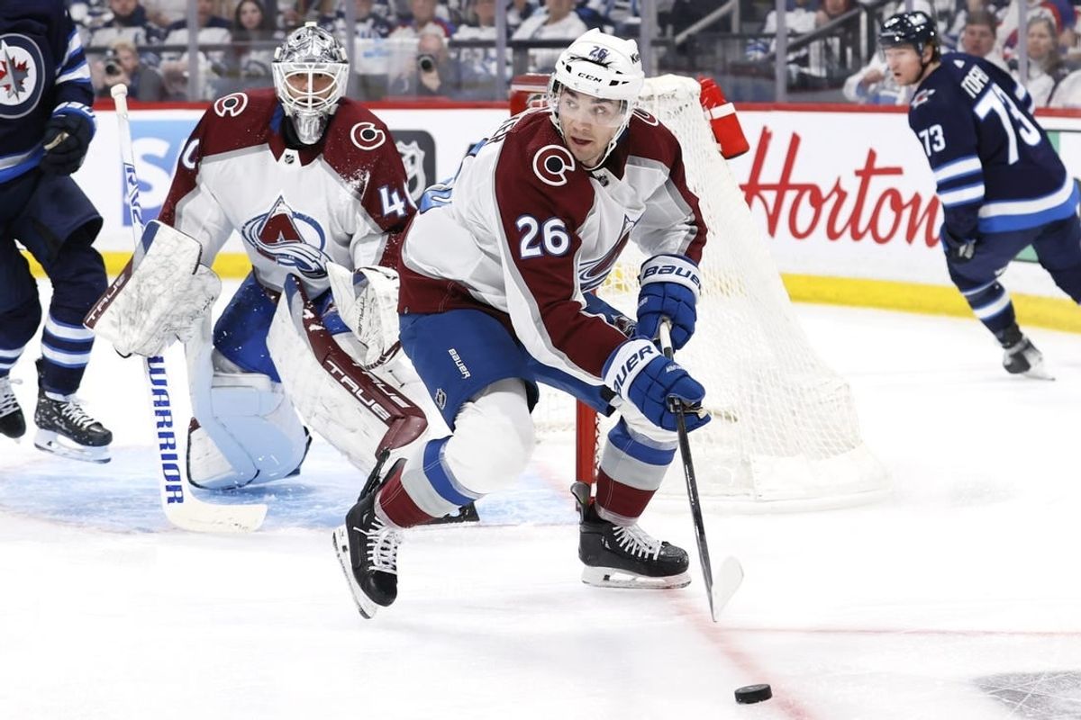 Apr 21, 2024; Winnipeg, Manitoba, CAN; Colorado Avalanche defenseman Sean Walker (26) clears the puck from in front of Colorado Avalanche goaltender Alexandar Georgiev (40) in the second period against the Winnipeg Jets in game one of the first round of the 2024 Stanley Cup Playoffs at Canada Life Centre.