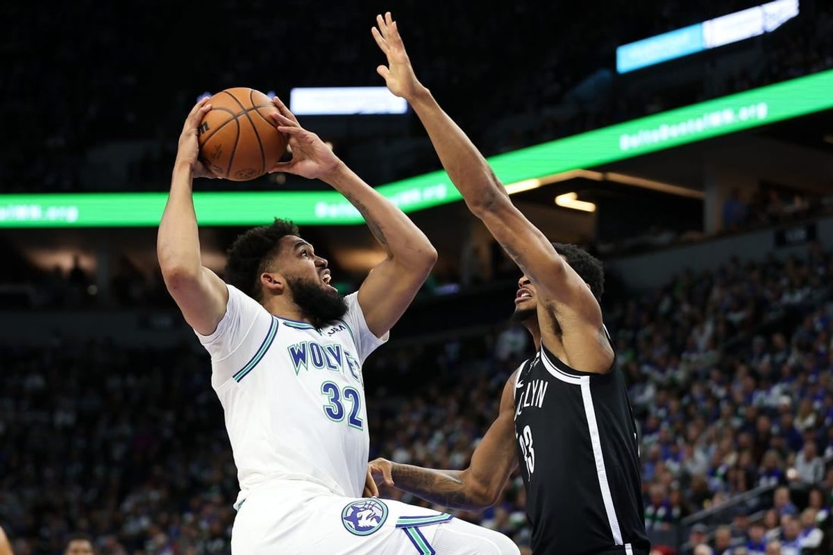 Feb 24, 2024; Minneapolis, Minnesota, USA; Minnesota Timberwolves center Karl-Anthony Towns (32) shoots as Brooklyn Nets center Nic Claxton (33) defends during the first half at Target Center.
