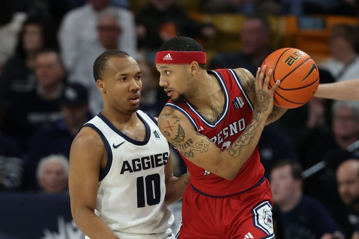 Jan 20, 2024; Logan, Utah, USA; Fresno State Bulldogs guard Isaiah Hill (3) looks to move the ball against Utah State Aggies guard Darius Brown II (10) during the first half at Dee Glen Smith Spectrum.