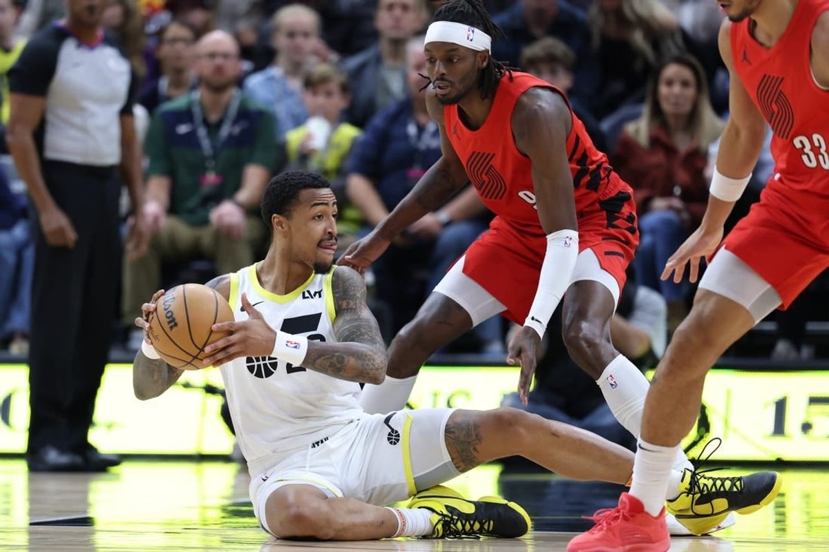Dec 2, 2023; Salt Lake City, Utah, USA; Utah Jazz forward John Collins (20) plays a ball from the floor against Portland Trail Blazers forward Jerami Grant (9) during the first quarter at Delta Center.