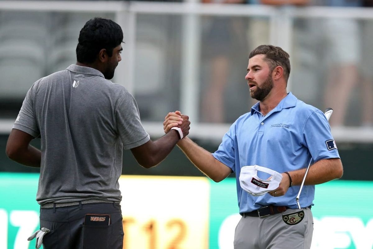 Oct 2, 2021; Jackson, Mississippi, USA; Sahith Theegala and Cameron Young shake hands on the 18th green after their third round of the Sanderson Farms Championship at the Country Club of Jackson.