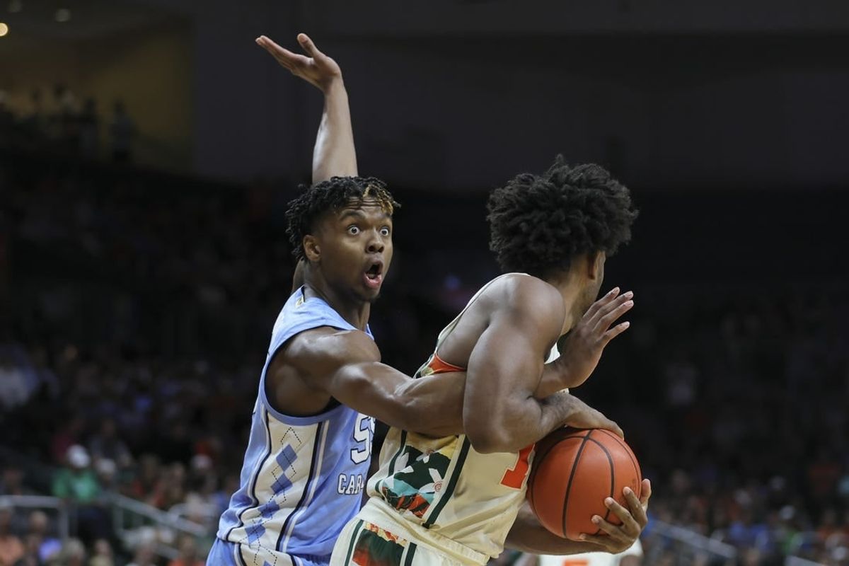 Feb 10, 2024; Coral Gables, Florida, USA; North Carolina Tar Heels forward Harrison Ingram (55) reacts as he guards Miami Hurricanes forward Norchad Omier (15) during the first half at Watsco Center.