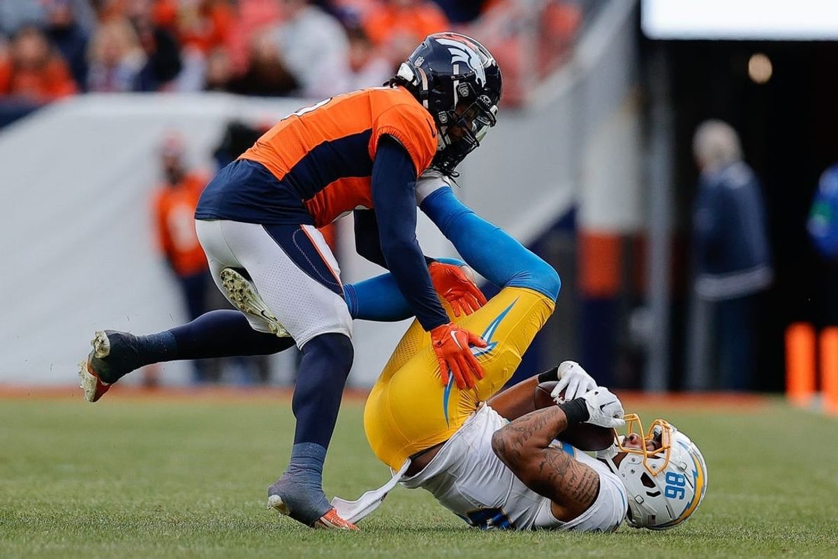 Dec 31, 2023; Denver, Colorado, USA; Denver Broncos safety P.J. Locke (6) gets caught up with Los Angeles Chargers wide receiver Keelan Doss (86) in the second quarter at Empower Field at Mile High.