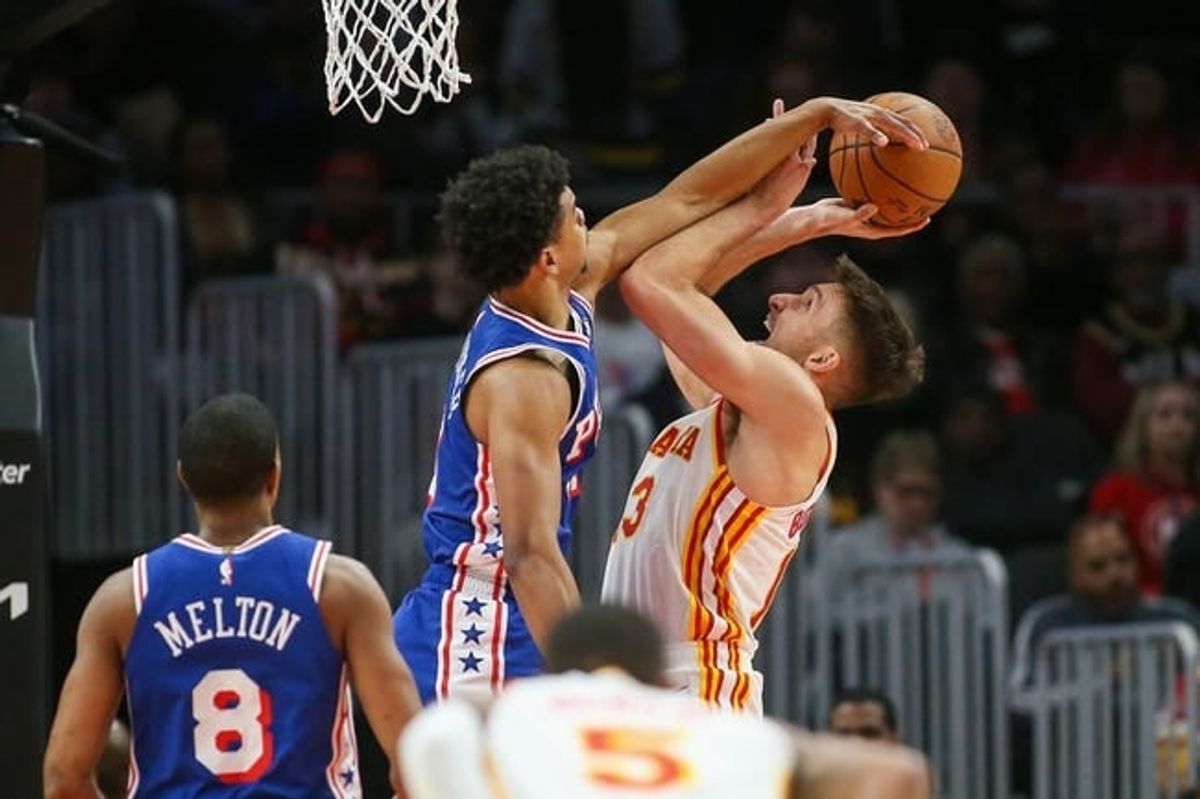 Jan 10, 2024; Atlanta, Georgia, USA; Philadelphia 76ers guard Jaden Springer (11) fouls Atlanta Hawks guard Bogdan Bogdanovic (13) on a block attempt in the second quarter at State Farm Arena.