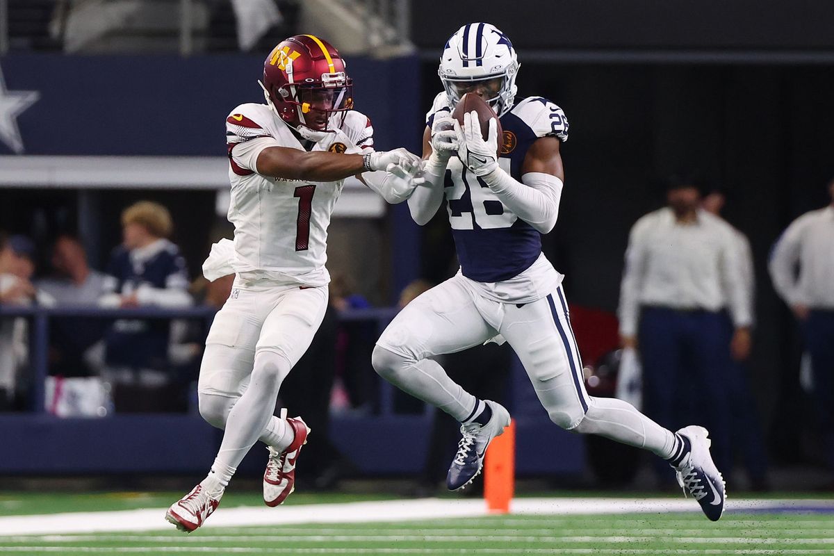 ARLINGTON, TEXAS - NOVEMBER 23: DaRon Bland #26 of the Dallas Cowboys intercepts a pass intended for Jahan Dotson #1 of the Washington Commanders during the fourth quarter at AT&T Stadium on November 23, 2023 in Arlington, Texas. (Photo by Richard Rodriguez/Getty Images)
