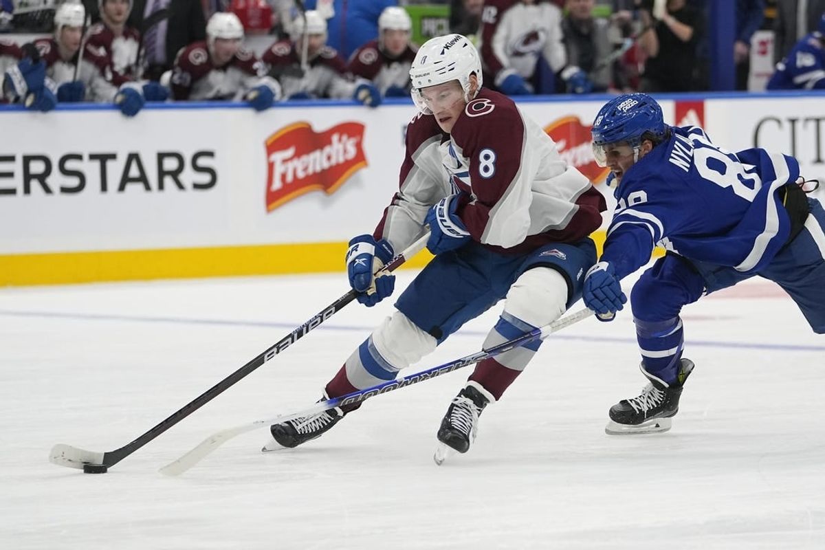 Jan 13, 2024; Toronto, Ontario, CAN; Colorado Avalanche defenseman Cale Makar (8) takes the puck away from Toronto Maple Leafs forward William Nylander (88) during the third period at Scotiabank Arena.