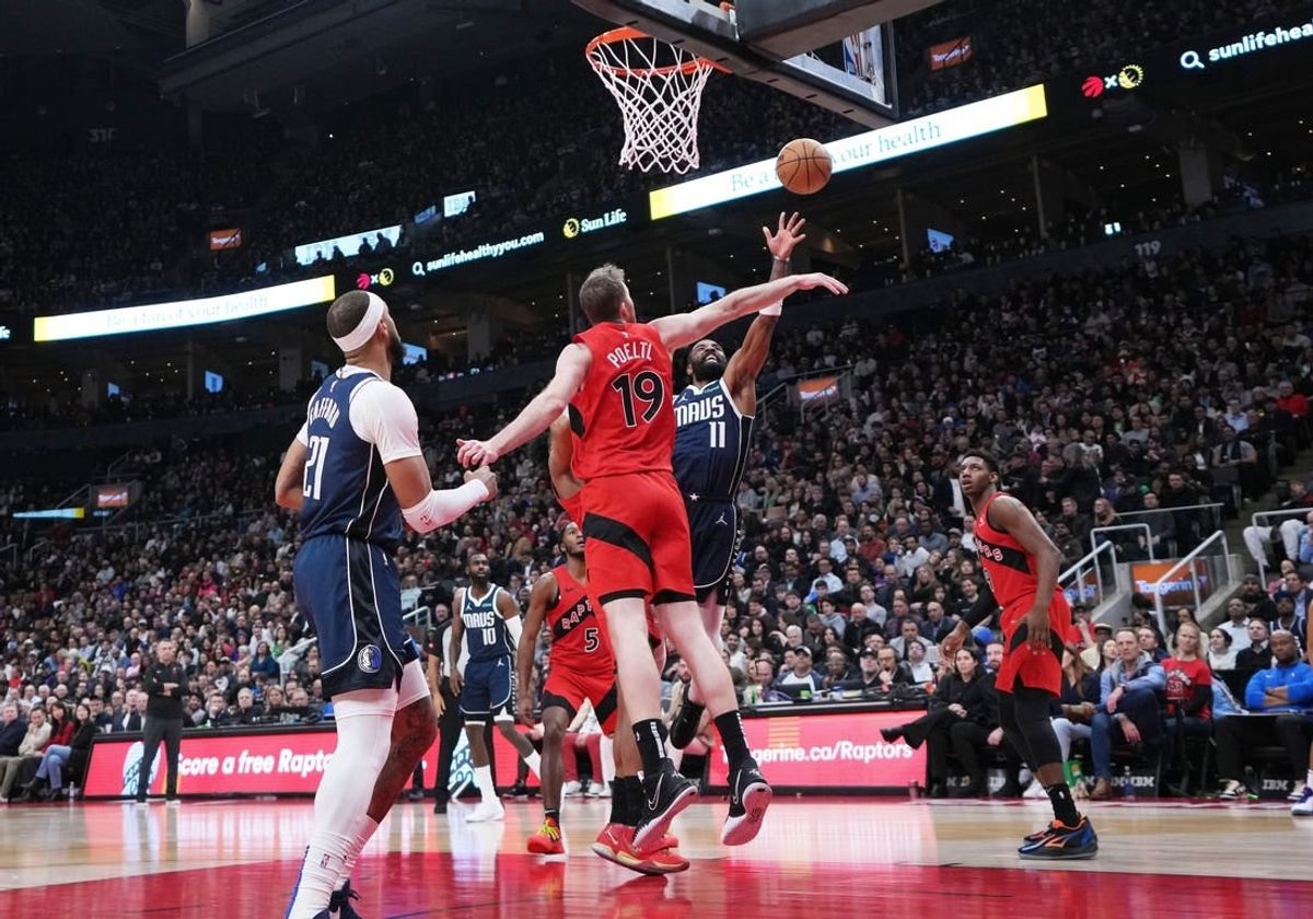 Feb 28, 2024; Toronto, Ontario, CAN; Dallas Mavericks guard Kyrie Irving (11) drives to the basket as Toronto Raptors center Jakob Poeltl (19) tries to defend during the second quarter at Scotiabank Arena.