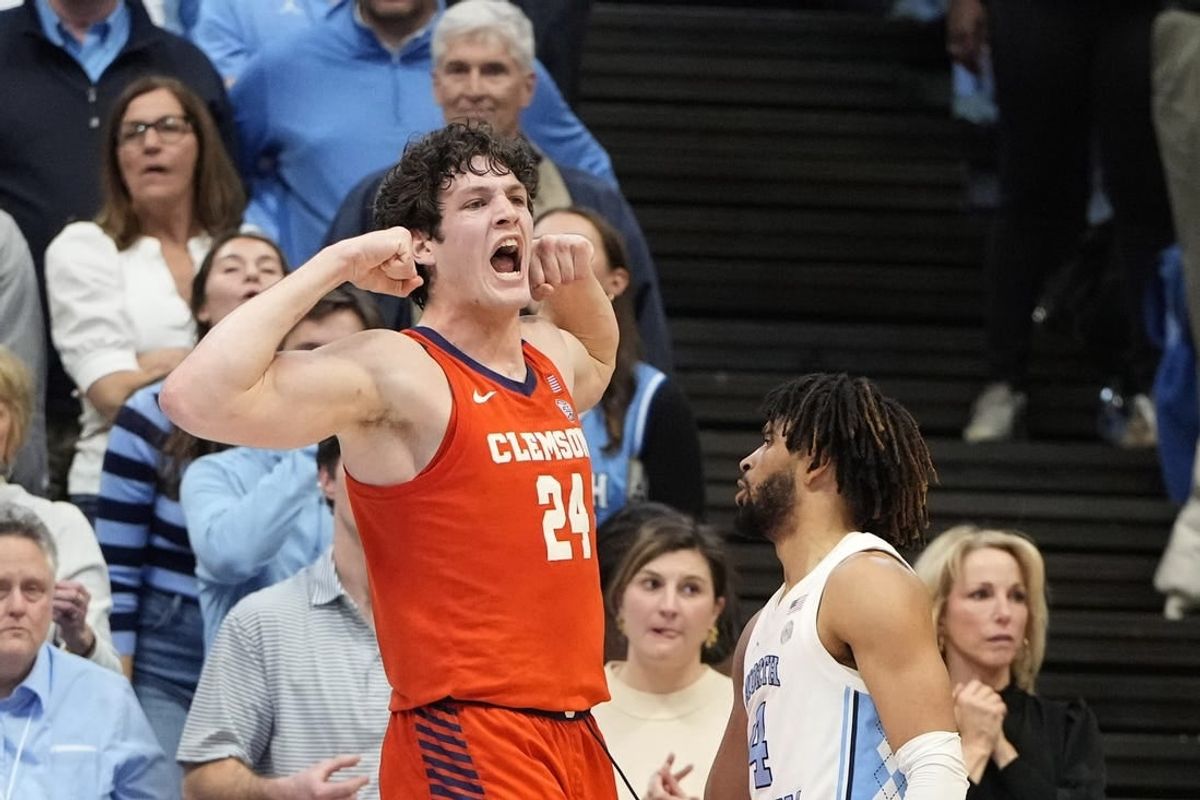 Feb 6, 2024; Chapel Hill, North Carolina, USA; Clemson Tigers center PJ Hall (24) and North Carolina Tar Heels guard RJ Davis (4) react in the second half at Dean E. Smith Center.