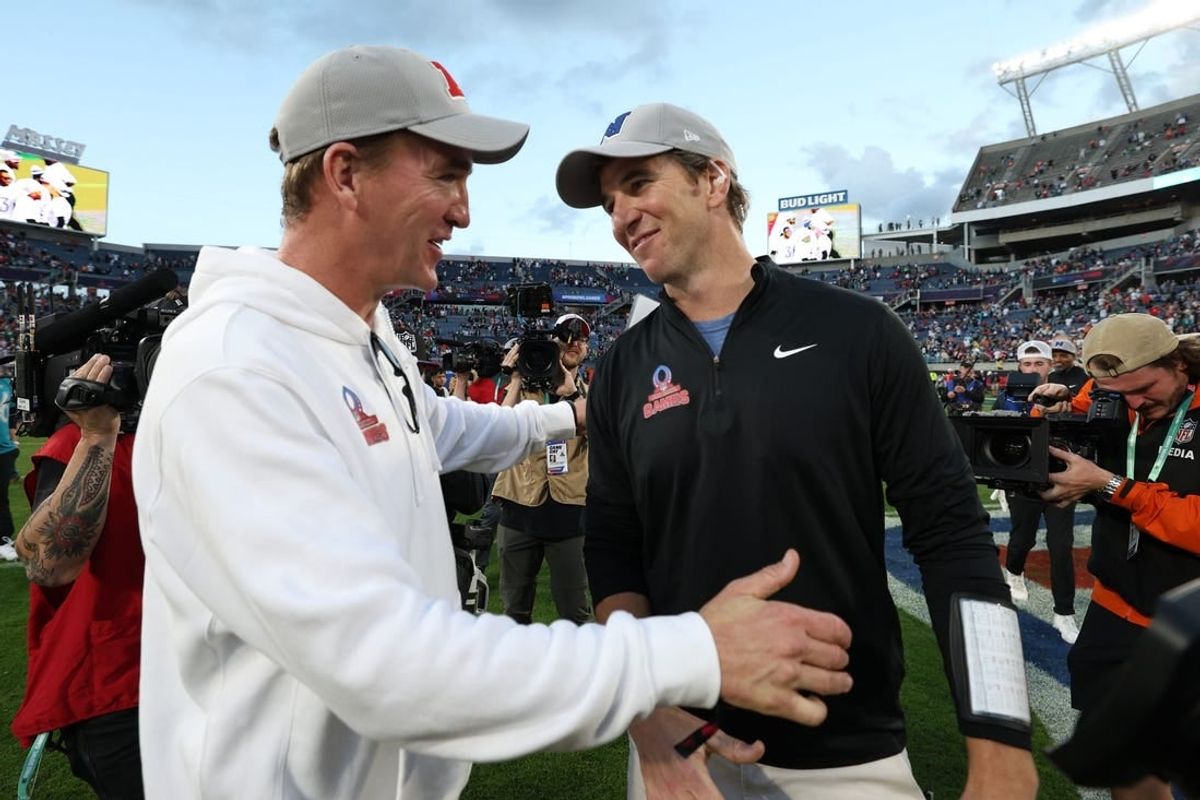 Feb 4, 2024; Orlando, FL, USA; NFC coach Eli Manning and AFC coach Peyton Manning react after the 2024 Pro Bowl at Camping World Stadium.