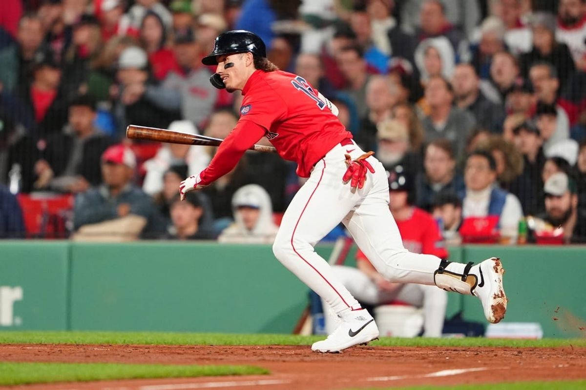 May 10, 2024; Boston, Massachusetts, USA; Boston Red Sox center fielder Jarren Duran (16) hits an infield single against the Washington Nationals during the fifth inning at Fenway Park.