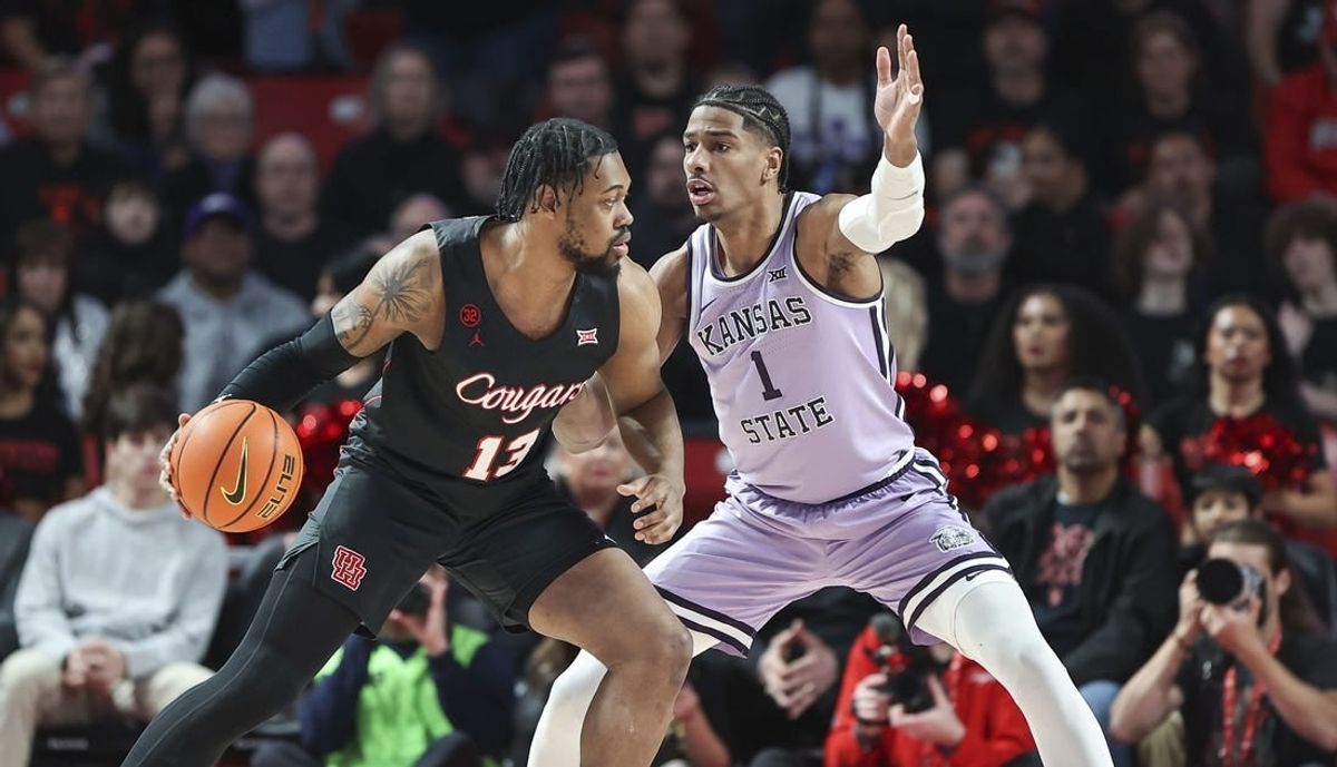 Jan 27, 2024; Houston, Texas, USA; Houston Cougars forward J'Wan Roberts (13) controls the ball as Kansas State Wildcats forward David N'Guessan (1) defends during the first half at Fertitta Center.