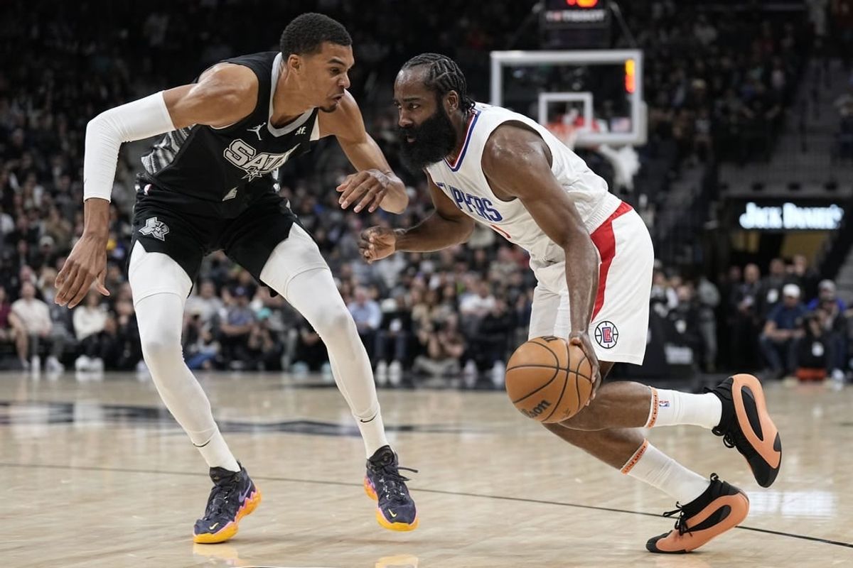 Nov 22, 2023; San Antonio, Texas, USA; Los Angeles Clippers guard James Harden (1) drives to the basket against San Antonio Spurs forward Victor Wembanyama (1) during the first half at Frost Bank Center.