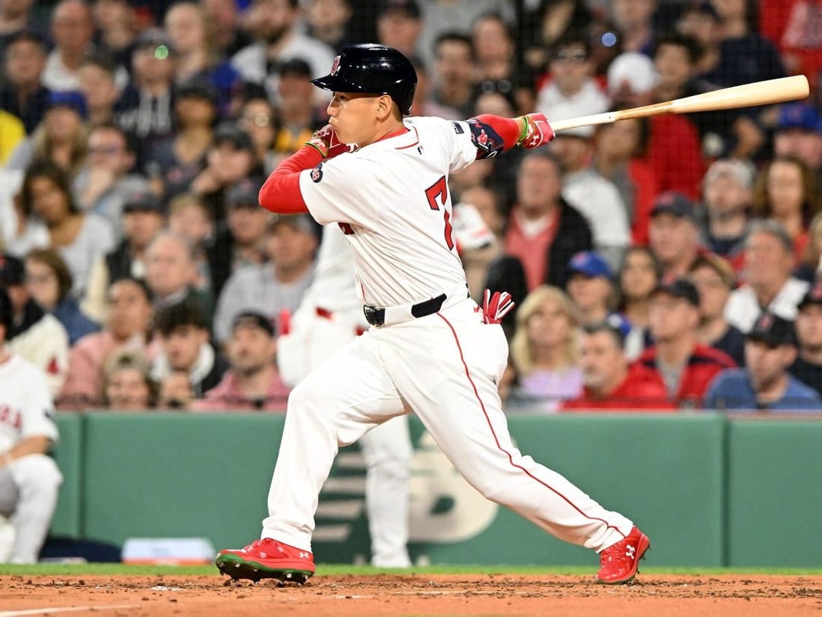 Apr 28, 2024; Boston, Massachusetts, USA;  Boston Red Sox left fielder Masataka Yoshida (7) hits a RBI single against the Chicago Cubs during the third inning at Fenway Park.