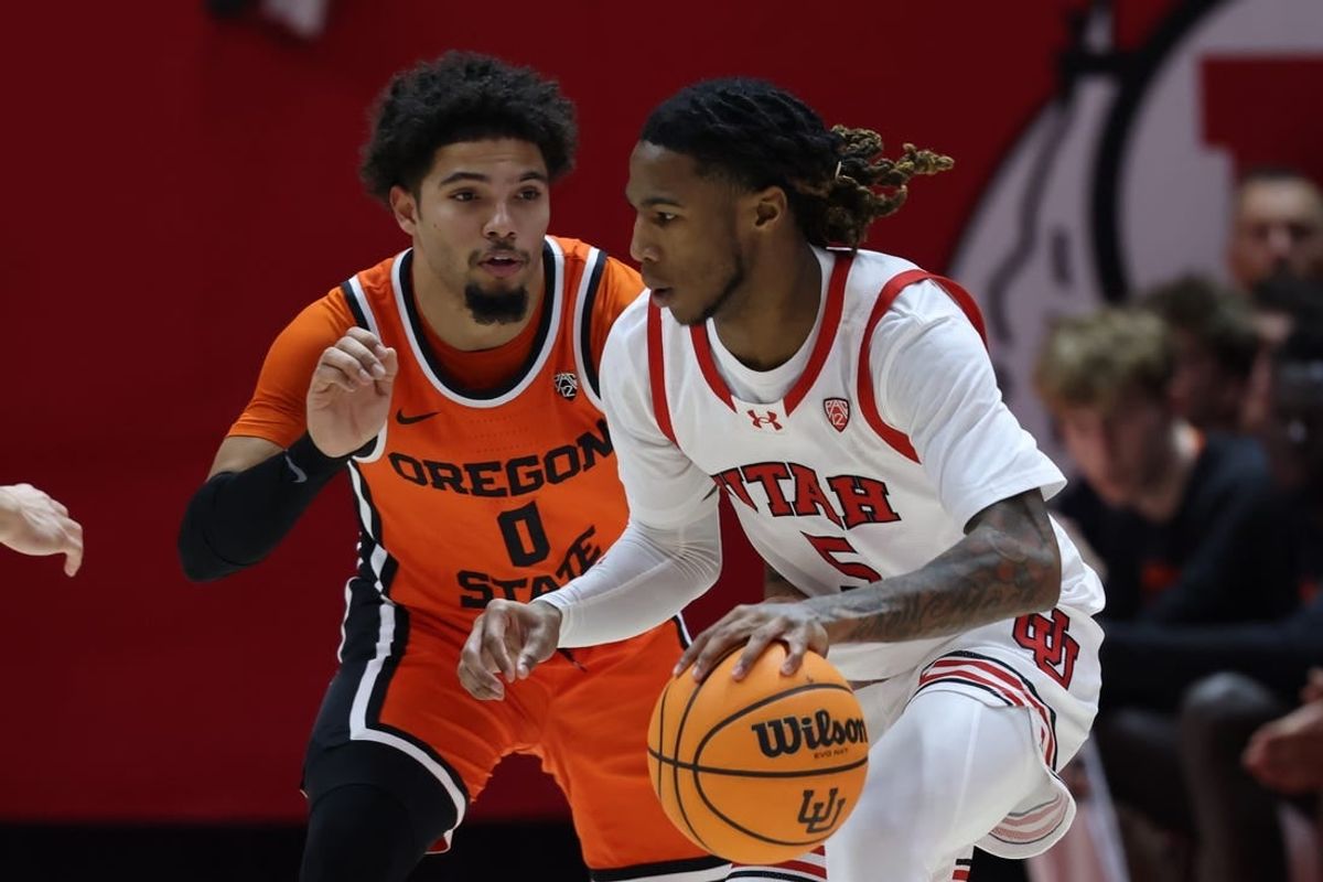 Jan 18, 2024; Salt Lake City, Utah, USA; Utah Utes guard Deivon Smith (5) drives against Oregon State Beavers guard Jordan Pope (0) during the first half at Jon M. Huntsman Center.