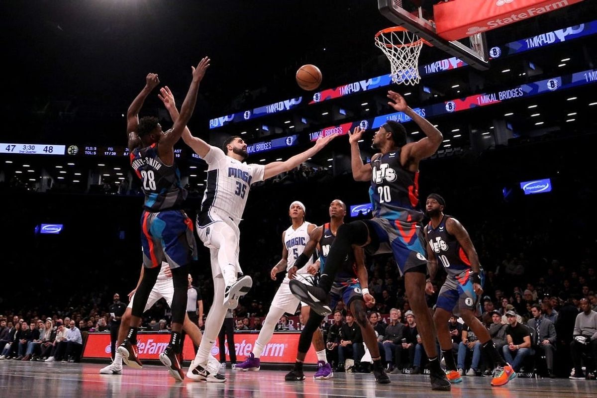 Nov 14, 2023; Brooklyn, New York, USA; Orlando Magic center Goga Bitadze (35) fights for a rebound against Brooklyn Nets forward Dorian Finney-Smith (28) and center Day'Ron Sharpe (20) during the second quarter at Barclays Center.