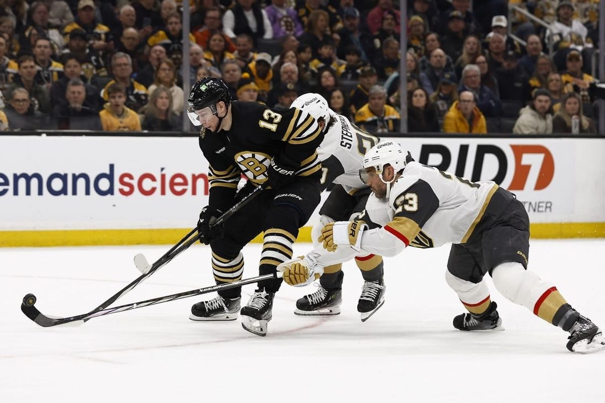 Feb 29, 2024; Boston, Massachusetts, USA; Vegas Golden Knights defenseman Alec Martinez (23) knocks the puck off the stick of Boston Bruins center Charlie Coyle (13) during the first period at TD Garden.