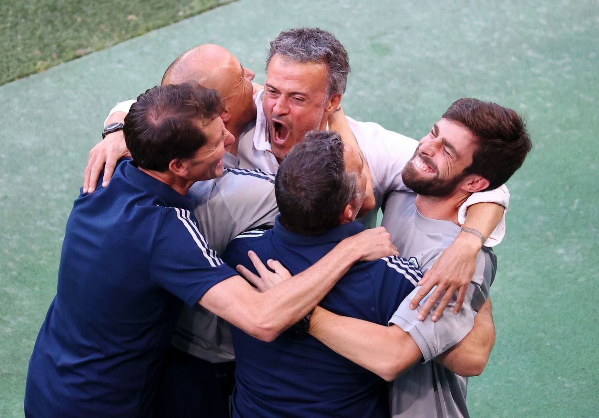 Luis Enrique celebrates with other members of Spain’s coaching staff after a rollercoaster of a match.