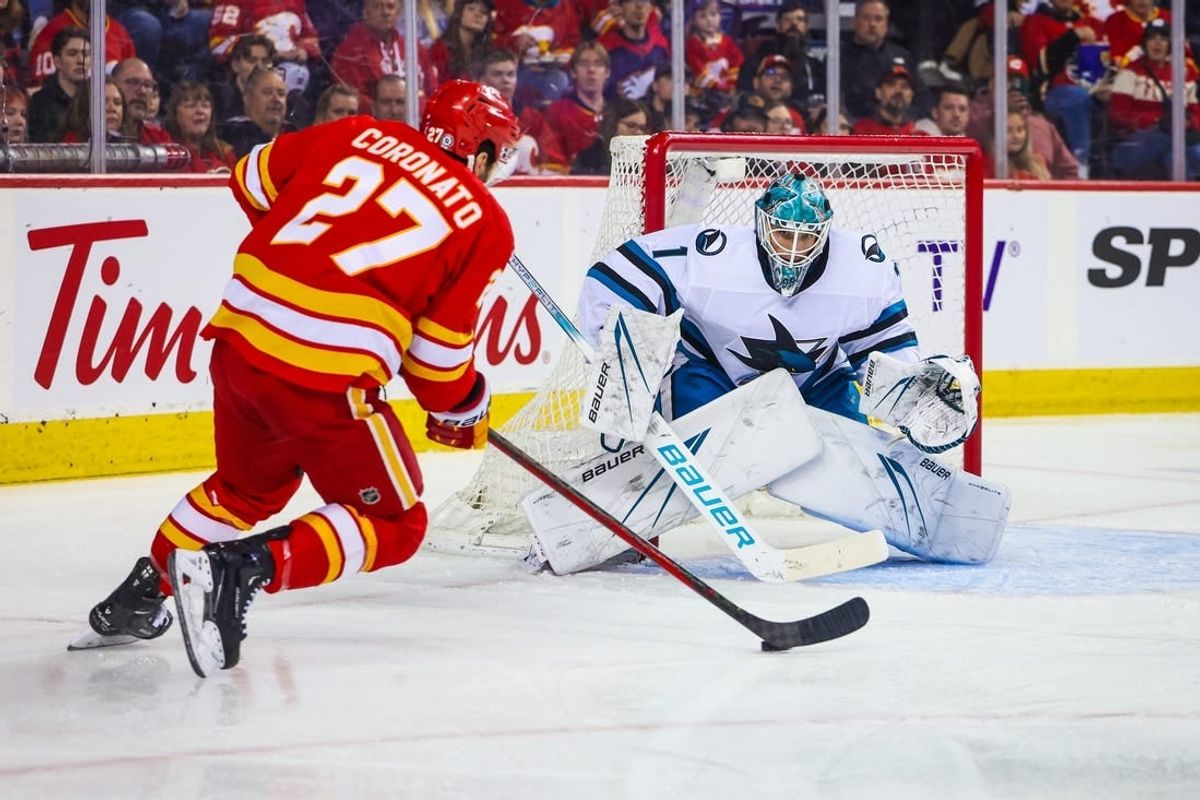 Apr 18, 2024; Calgary, Alberta, CAN; San Jose Sharks goaltender Devin Cooley (1) guards his net against Calgary Flames right wing Matt Coronato (27) during the second period at Scotiabank Saddledome.