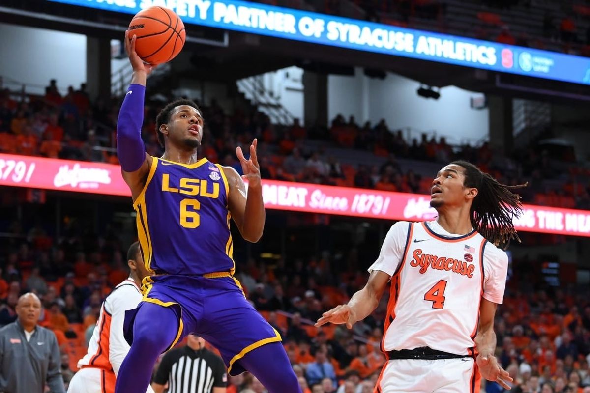 Nov 28, 2023; Syracuse, New York, USA; LSU Tigers guard Jordan Wright (6) shoots the ball as Syracuse Orange forward Chris Bell (4) defends during the first half at the JMA Wireless Dome.