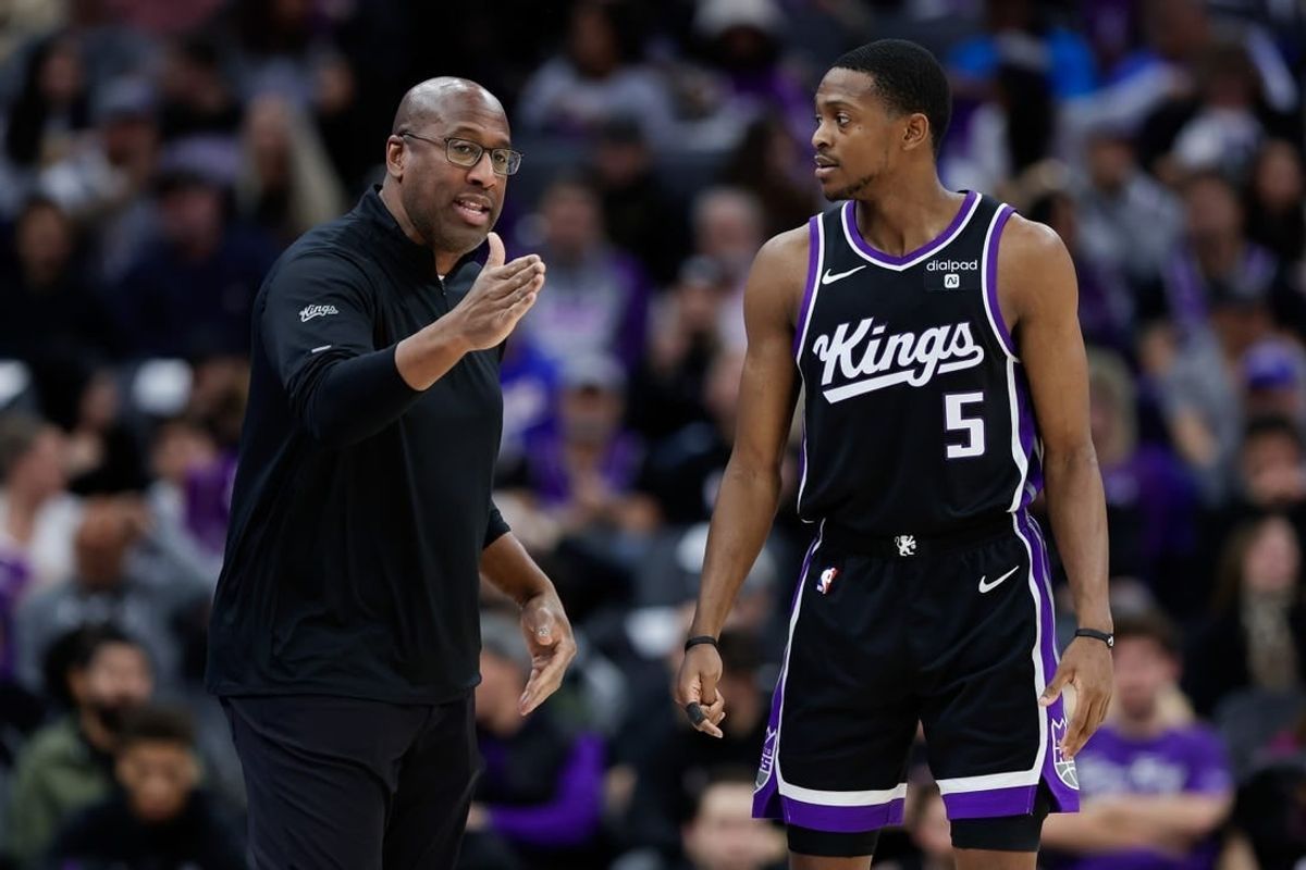 Jan 3, 2024; Sacramento, California, USA; Sacramento Kings head coach Mike Brown talks with guard De'Aaron Fox (5) during the third quarter against the Orlando Magic at Golden 1 Center.